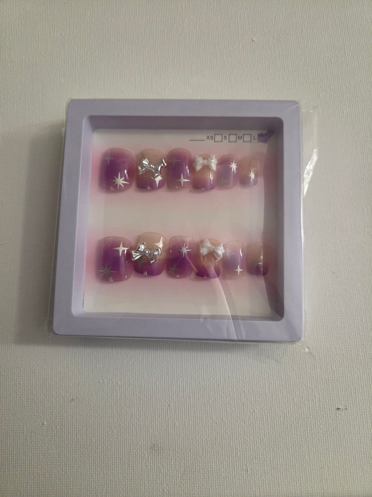 Purple ombre silver bow press-on nail set with white bow and 4-point stars