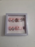 Brown cow print press-on nail set with silver bow charm and white butterfly accent