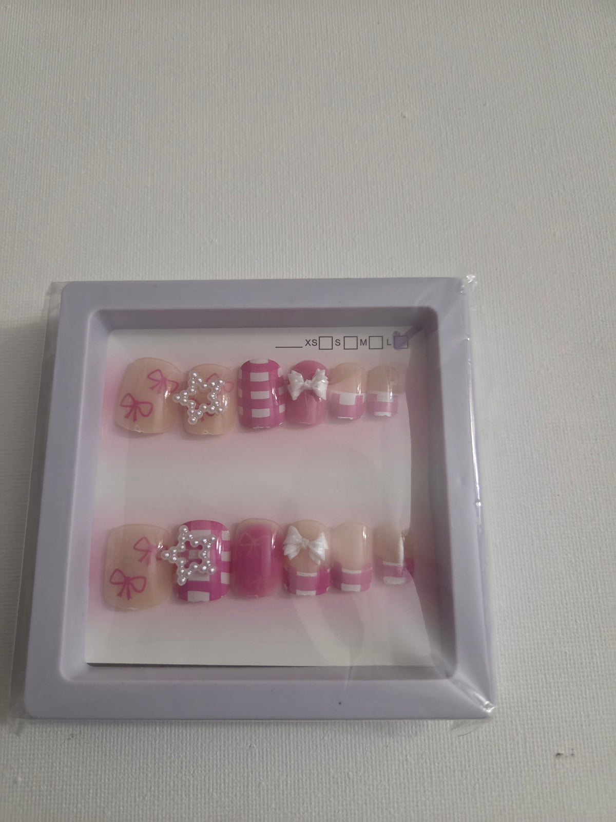 Pink glitter stars and bow press-on nail set with silver glitter and 3D white bow