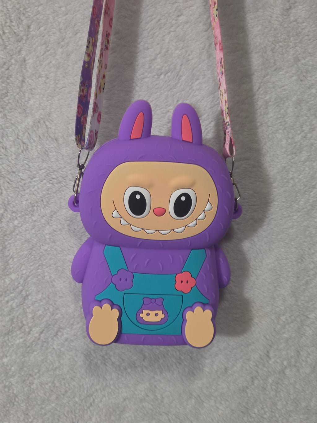 Purple Labubu-inspired monster bunny silicone crossbody bag full view with pink floral adjustable strap