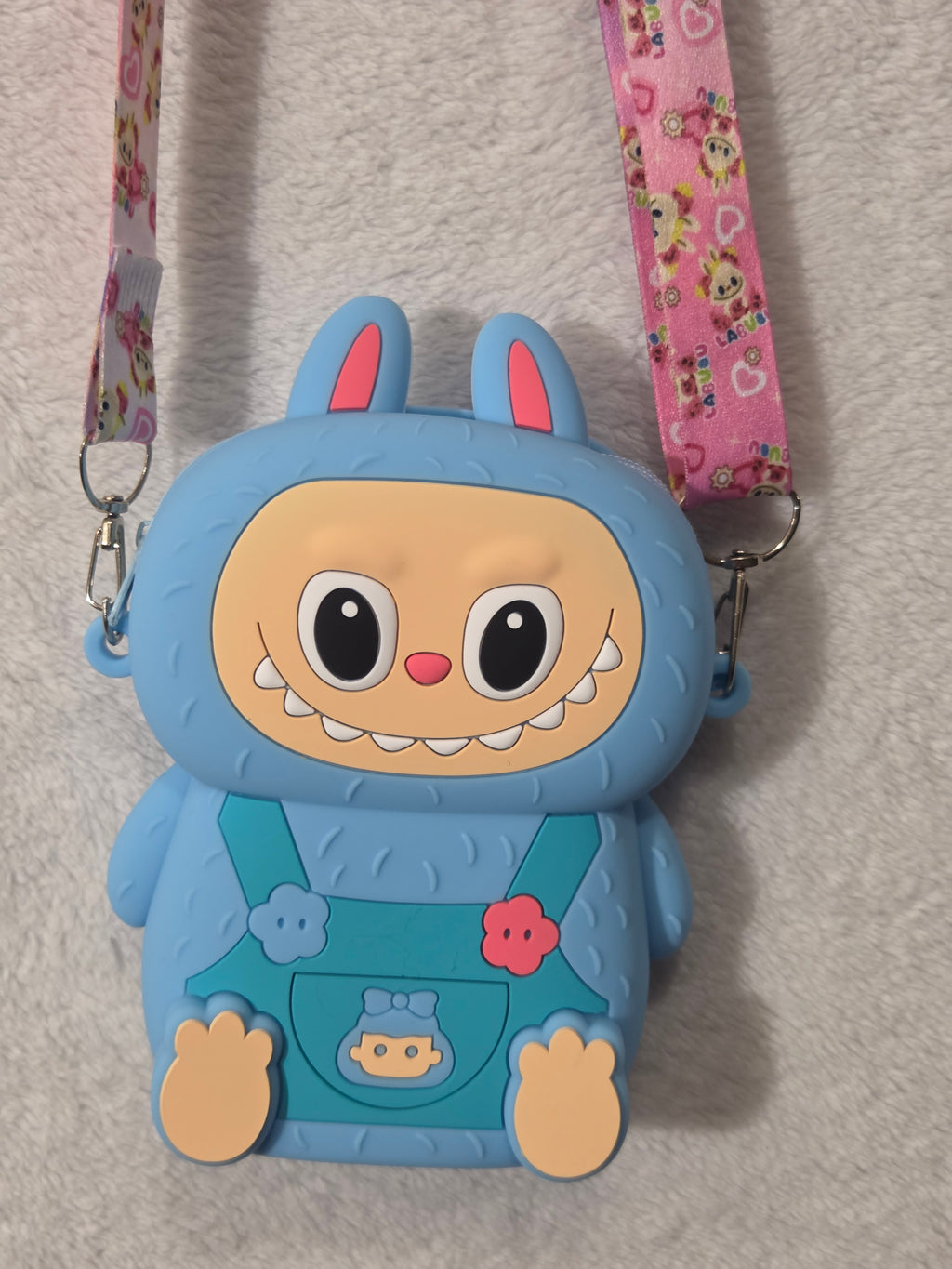 Blue Labubu-inspired monster bunny silicone crossbody bag back view showing smooth blue silicone body