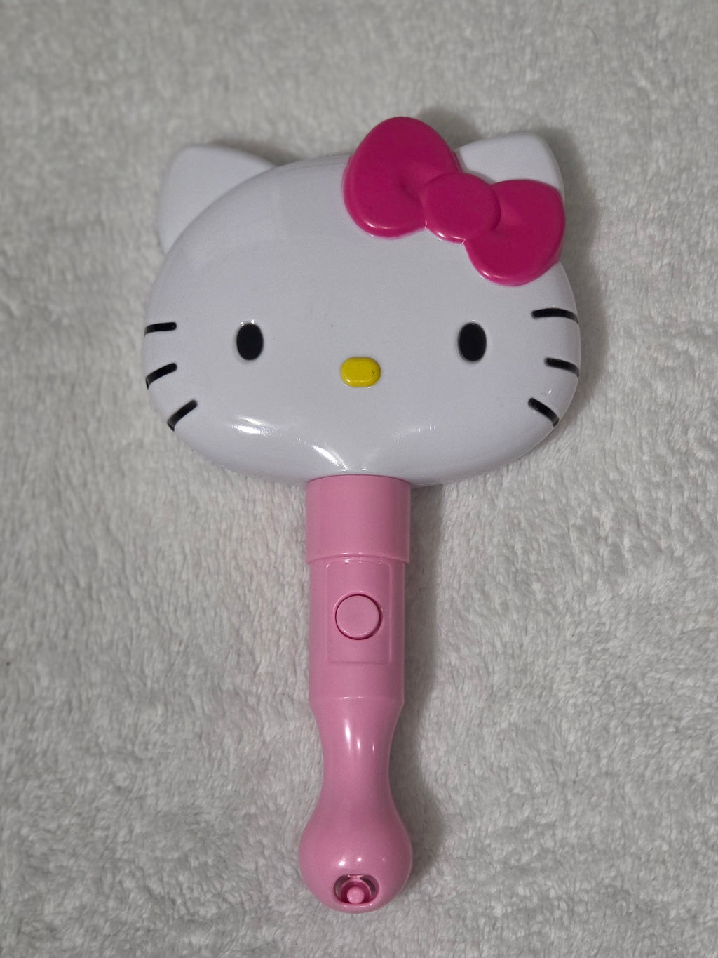 Sanrio Hello Kitty LED Light-Up Mirror — handle and power switch detail