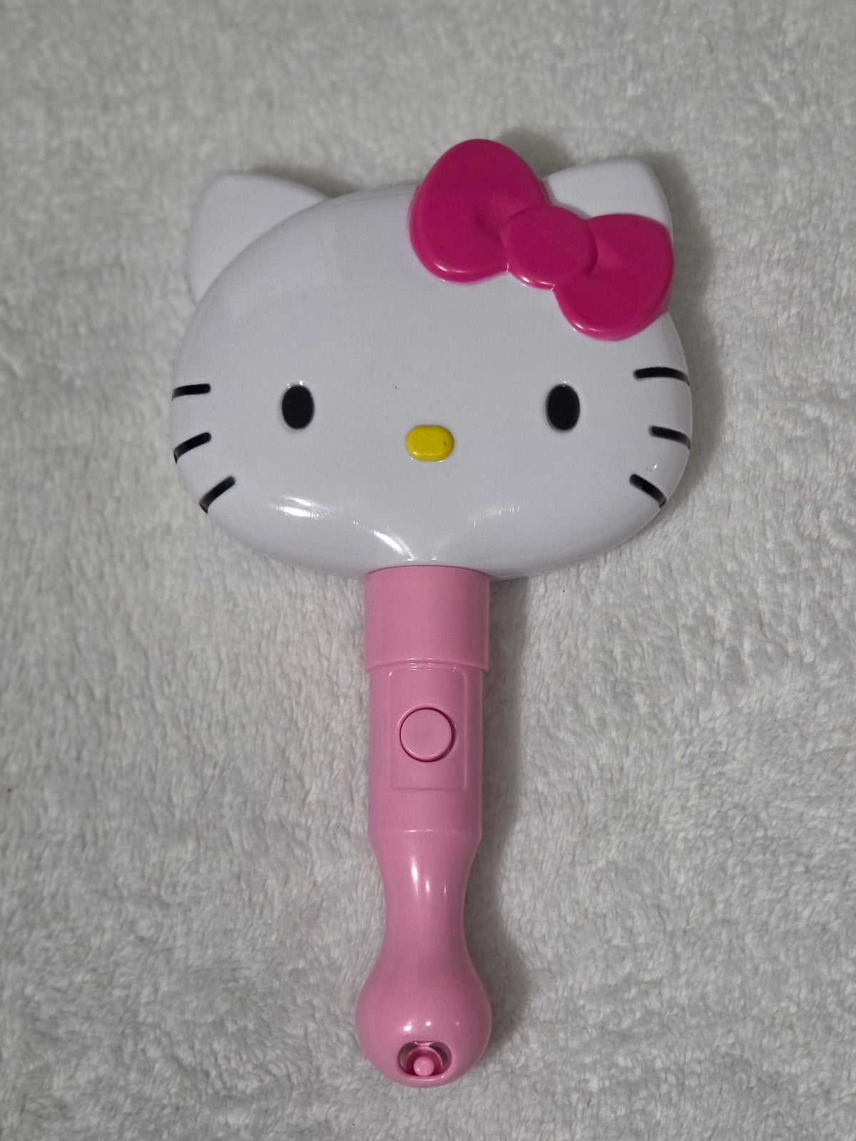 Sanrio Hello Kitty LED Light-Up Mirror — handle and power switch detail