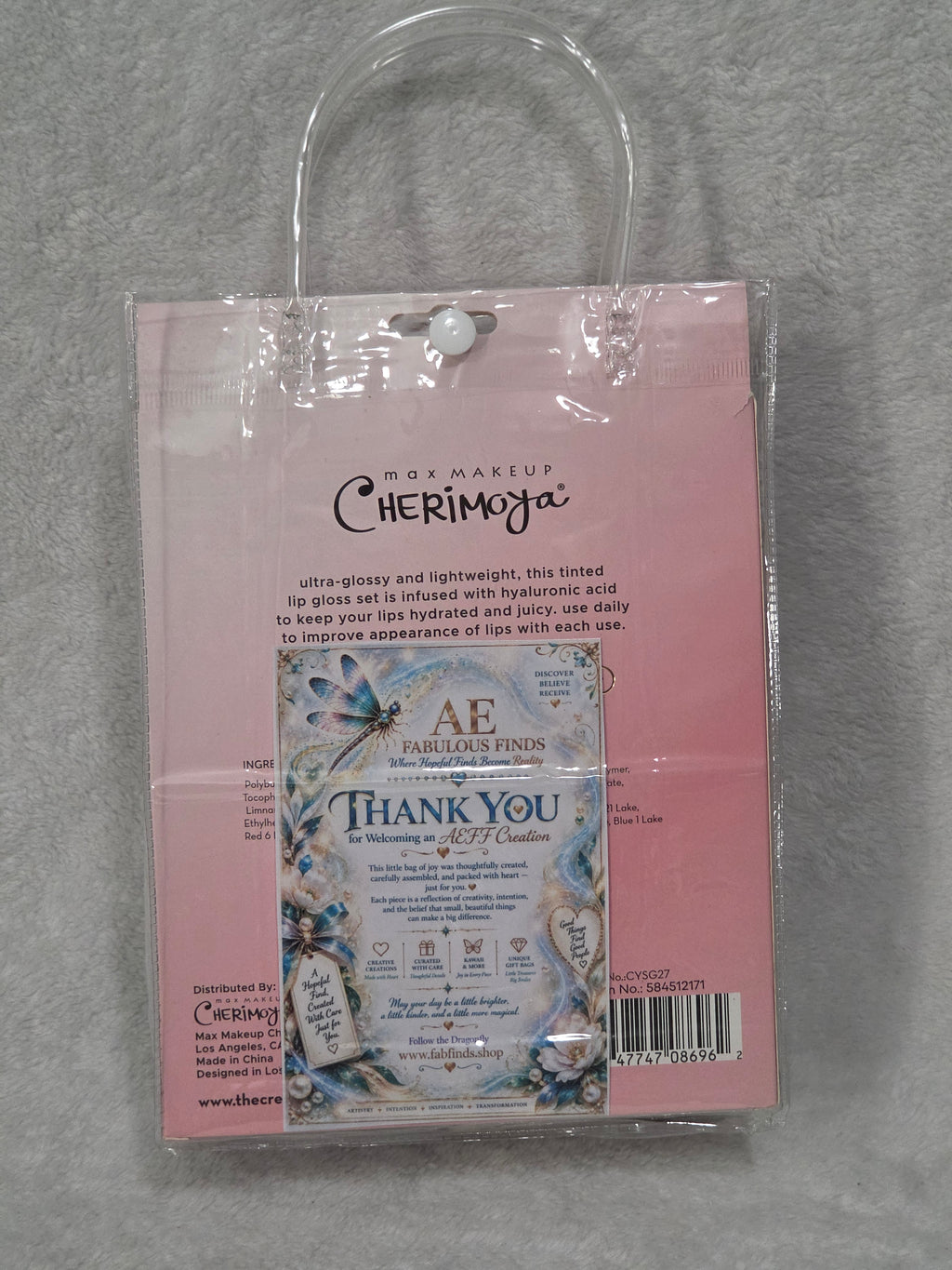 Beauty Bag Glam and Glow — empty clear PVC bag with silver trim, rhinestone dragonfly and purple flower detail