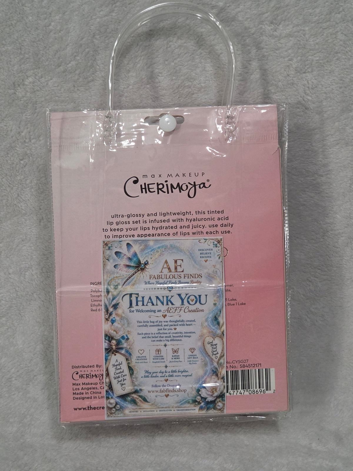 Beauty Bag Glam and Glow — empty clear PVC bag with silver trim, rhinestone dragonfly and purple flower detail