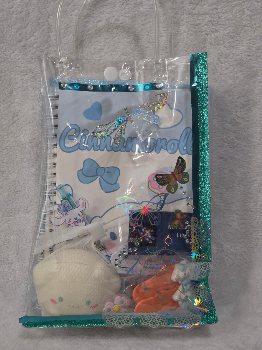 Empty AEFF teal glitter tote showing holographic butterfly print, rhinestone dragonfly and teal lace trim detail