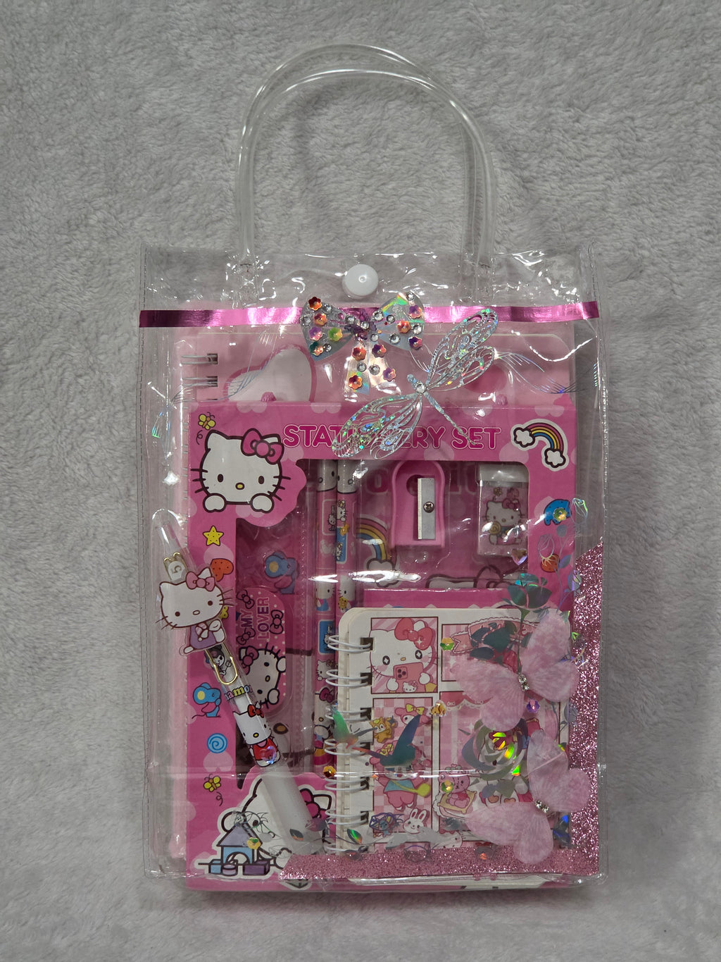 Hello Kitty Sweet Dreams — packed bag showing Hello Kitty stationery set and fuzzy journal through clear front