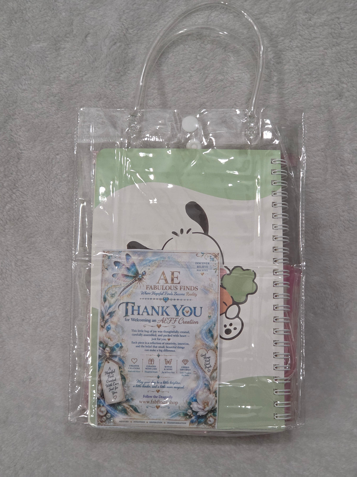 My Melody Happy Day — flat lay of all contents including Pachacco notebook, trifold wallet, light-up crossbody bag, pen and charm keychain