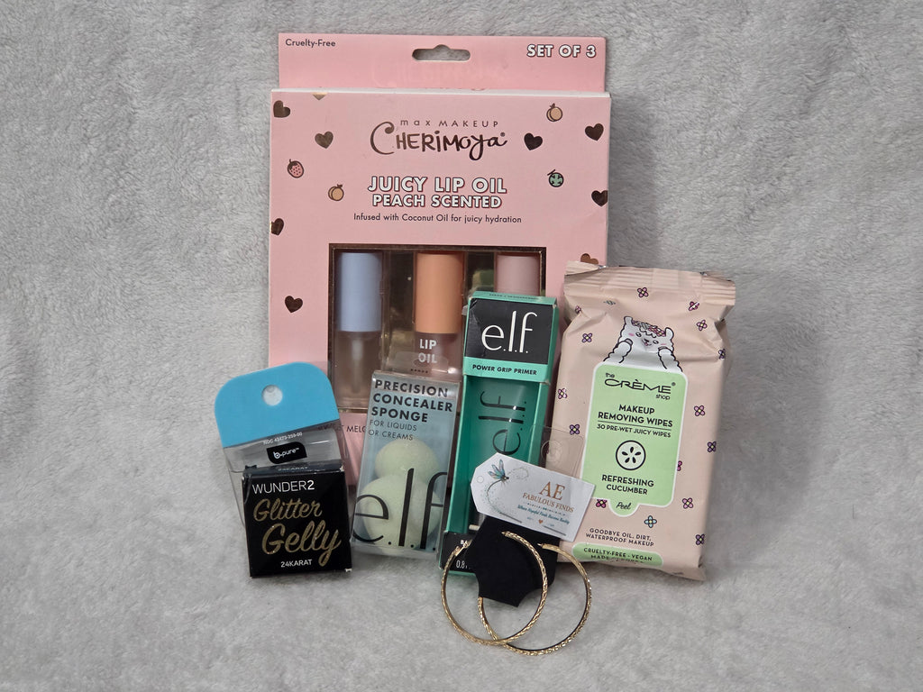 Beauty Bag Peach and Gold Glow — filled clear PVC bag with gold trim showing Cherimoya, e.l.f. and Wunder2 products through front