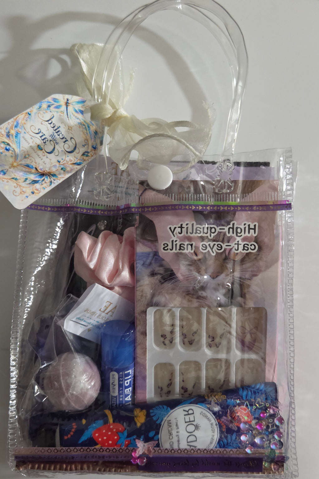 Back of purple Created with Care mini spa gift bag with AEFF thank-you card