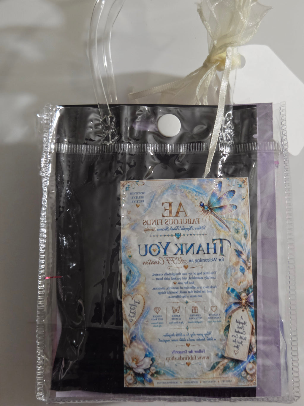 Purple Created with Care mini spa bag with cat-eye press-on nails and beauty treats