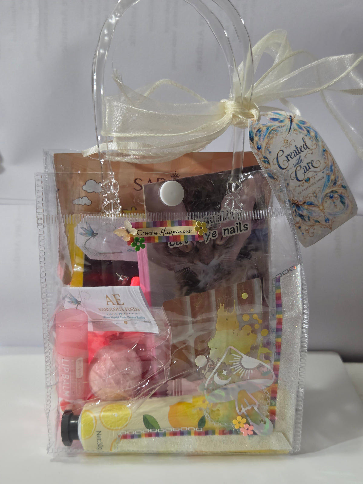Front of Create Happiness mini spa bag with ivory ribbon, yellow accents, and gift tag